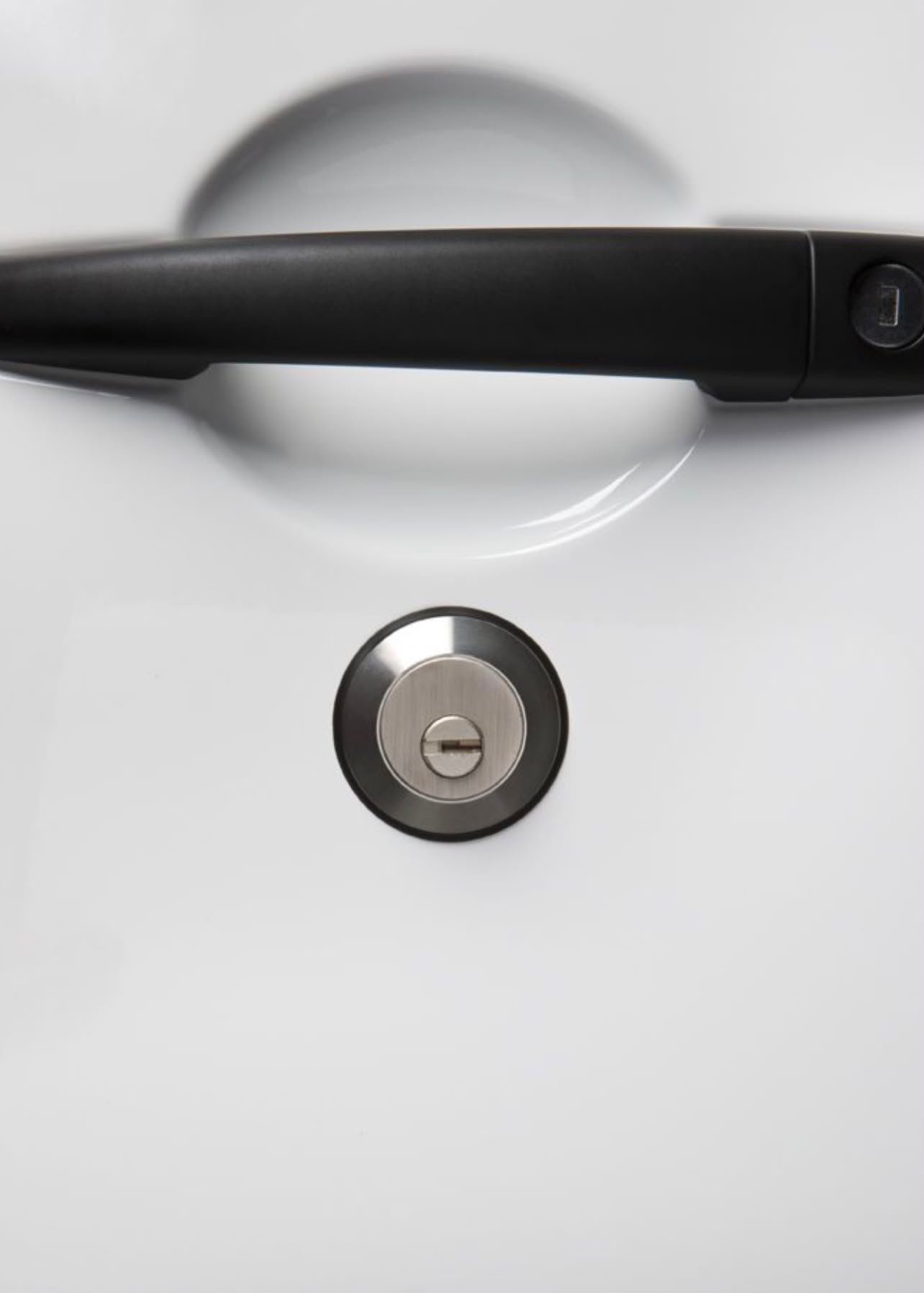 Slam lock cylinder and door handle, close up